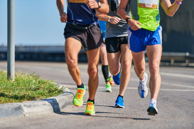 Marathon runners on city road. running competition. street sprinting outdoor. healthy lifestyle