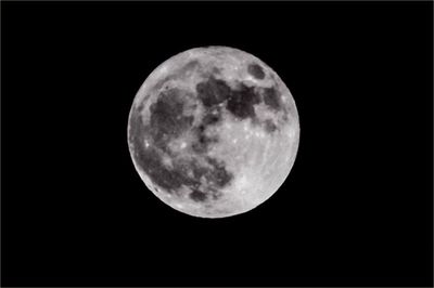 Close-up of full moon against clear sky at night