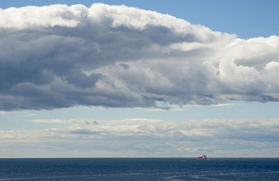 Scenic view of ship and sea against sky