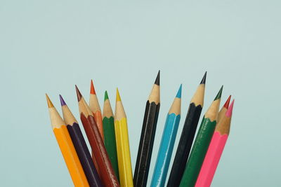 Close-up of colored pencils against white background