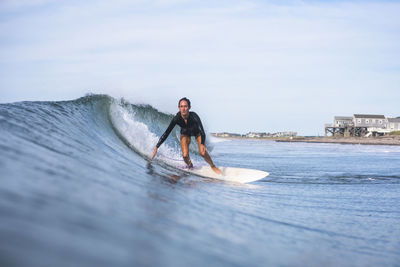 Woman surfing in rhode island summer