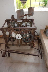 Old rusty bicycle on table against wall