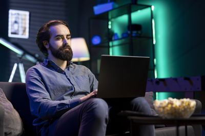 Young man using laptop at home