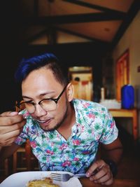 Young man sitting in restaurant