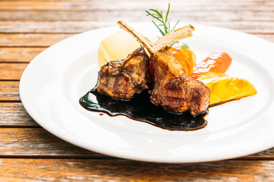 Close-up of roasted meat in plate on table