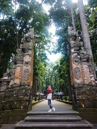 Rear view of woman walking in temple