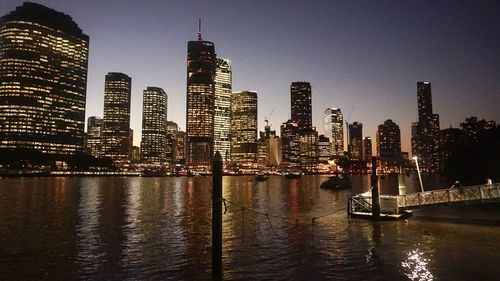 Illuminated city at waterfront