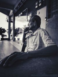 Thoughtful mature man sitting at table