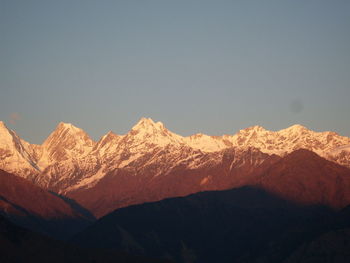 Scenic view of snowcapped mountains against clear sky