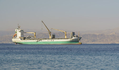 Ship sailing in sea against clear sky