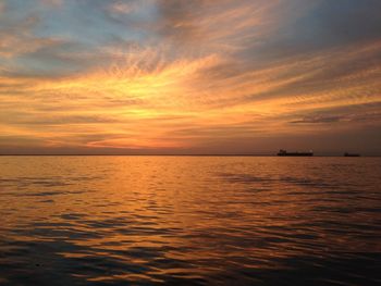 Scenic view of sea against orange sky