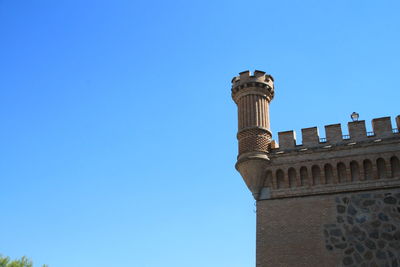 Low angle view of historic building against blue sky