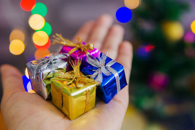 Close-up of hand holding ring in box