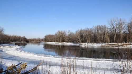 Scenic view of frozen lake against sky during winter