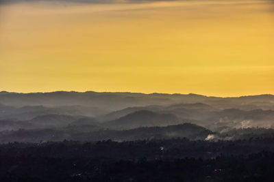 Scenic view of silhouette mountains against sky during sunset