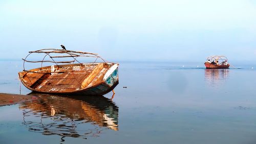 Abandoned ship in sea against sky