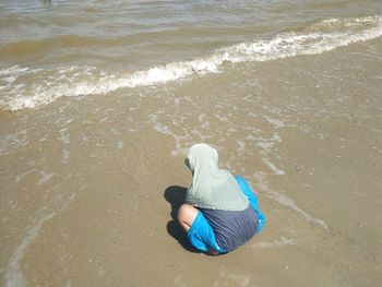 High angle view of man relaxing on beach