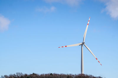 Low angle view of windmill against sky