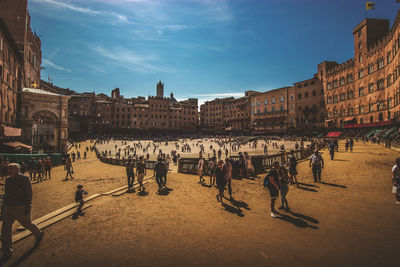 People on street in city against sky