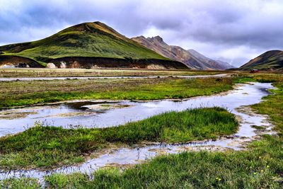 Scenic view of lake and mountains against sky