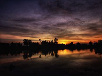 Scenic view of lake against orange sky