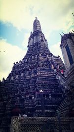 Low angle view of statue of temple against cloudy sky