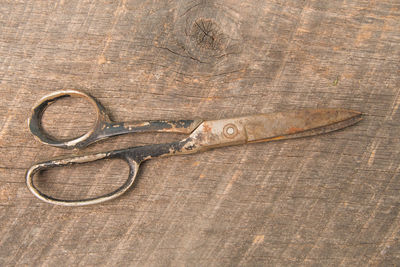 High angle view of old scissors on wooden table