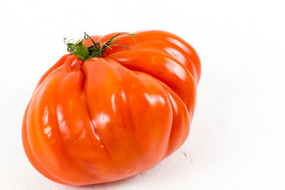 Close-up of orange over white background