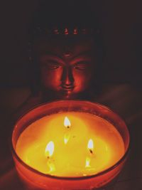 Close-up of illuminated tea light candle