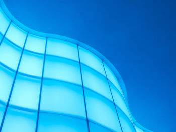 Low angle view of modern building against clear blue sky