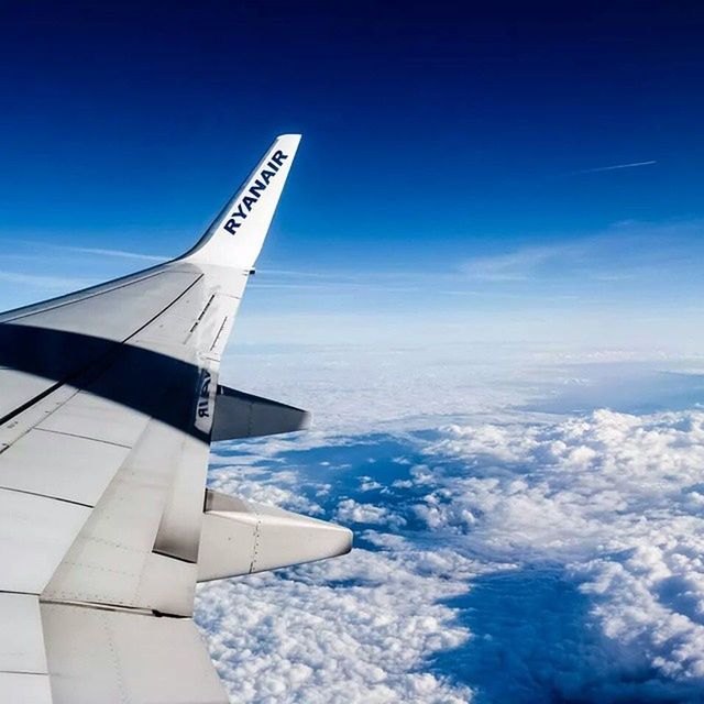 airplane, aircraft wing, transportation, flying, air vehicle, part of, blue, mode of transport, cropped, sky, travel, aerial view, journey, mid-air, on the move, cloud - sky, nature, scenics, airplane wing, public transportation