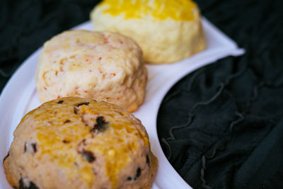 Homemade scones in various flavour on the dark background.