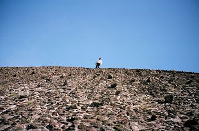 Full length of woman on landscape against clear sky