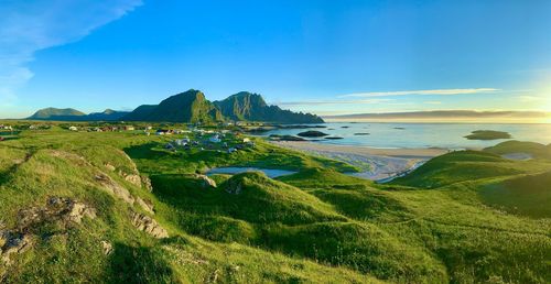 Scenic view of sea mountains against sky