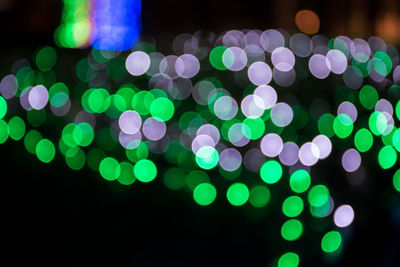 Defocused image of illuminated green lights