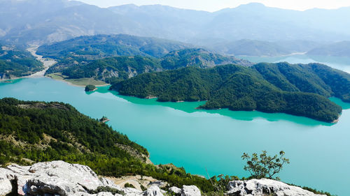 High angle view of lake amidst mountains against sky