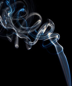 Close-up of abstract object over black background