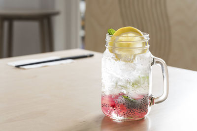 Close-up of drink in glass jar on table