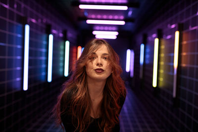 Portrait of young woman standing in city