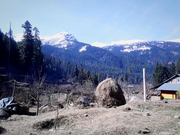 Snow covered landscape against mountain range