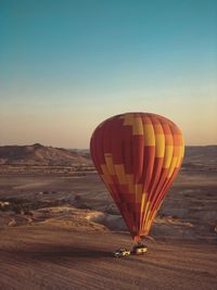 Hot air balloons against sky during sunset