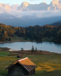 Scenic view of lake by mountains against sky