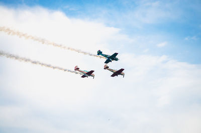 Low angle view of airshow against sky