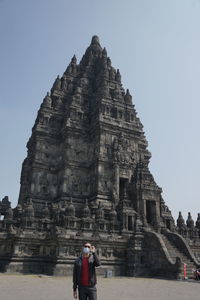 People at temple against sky