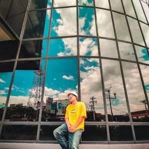 Man standing on construction site against sky
