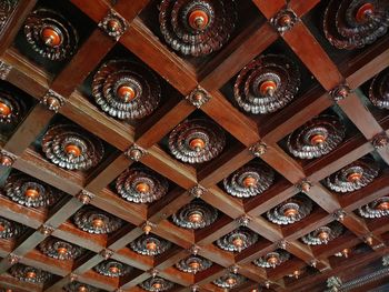 Low angle view of illuminated chandelier hanging in building