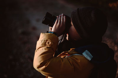 Rear view of man photographing