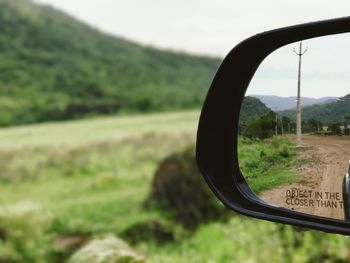 Reflection of road on side-view mirror