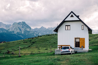 House on field against sky