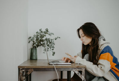 Young woman using laptop at home